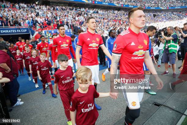 Phil Jones, Nemanja Matic and Chris Smalling of Manchester United walk out ahead of the Emirates FA Cup Final match between Manchester United and...