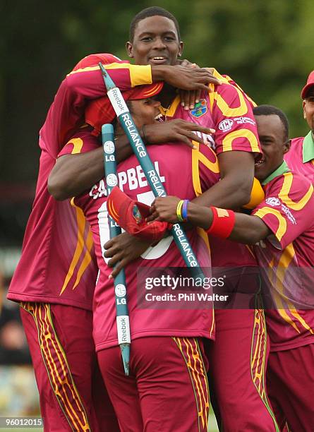 Jason Holder of the West Indies is hugged by John Campbell as he celebrates his wicket of David Payne of England to win the match during the ICC U19...