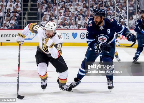 Tomas Tatar of the Vegas Golden Knights and Dustin Byfuglien of the Winnipeg Jets follow the play down the ice during first period action in Game Two...