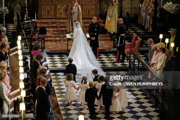 Britain's Prince Harry, Duke of Sussex and US actress Meghan Markle stand at the altar with their bridsesmaids and page boys in St George's Chapel,...
