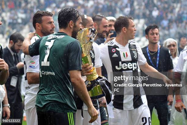 Juventus players holding the trophy after winning their seventh league titles in a row at the end of the serie A match between Juventus and Hellas...