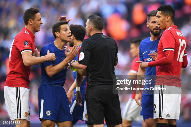 Nemanja Matic of Manchester United and Cesar Azpilicueta of Chelsea confront referee Michael Oliver during The Emirates FA Cup Final between Chelsea...