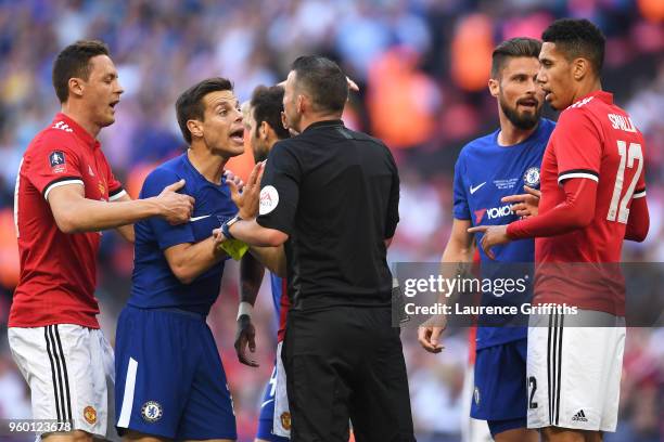 Nemanja Matic of Manchester United and Cesar Azpilicueta of Chelsea confront referee Michael Oliver during The Emirates FA Cup Final between Chelsea...