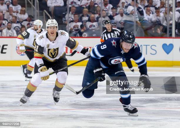 Andrew Copp of the Winnipeg Jets and Cody Eakin of the Vegas Golden Knights follow the play down the ice during third period action in Game Two of...