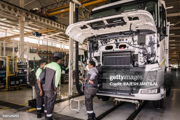 Employees carry out a demonstration in front of South African President Cyril Ramaphosa at the Volvo Automobile factory plant as he pays a visit to...