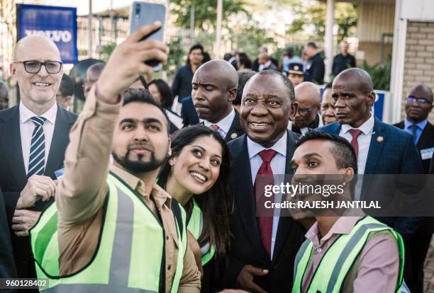 South Africa's President Cyril Ramaphosa poses for a 'selfie' with young entrepreneurs during a visit to the Volvo Automobile factory plant in Durban...