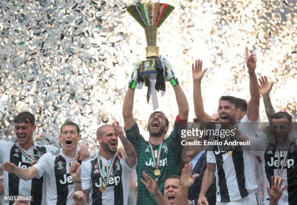 Gianluigi Buffon of Juventus FC lifts the Serie A trophy in his last match for the club as he celebrates winning the championship with team-mates at...