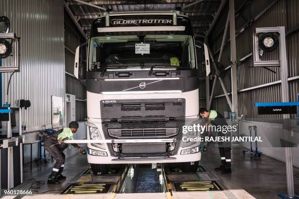 Employees carry out a demonstration in front of South African President Cyril Ramaphosa at the Volvo Automobile factory plant as he pays a visit to...