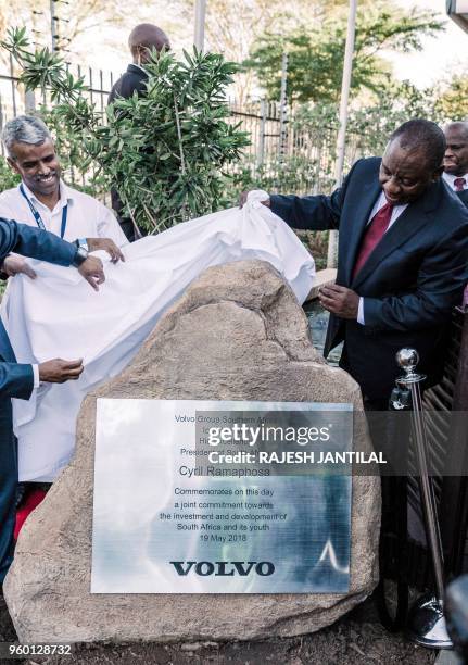 South African President Cyril Ramaphosa unveils a plaque at the Volvo Automobile factory plant in Durban on May 19, 2018. - Ramapahosa visited the...