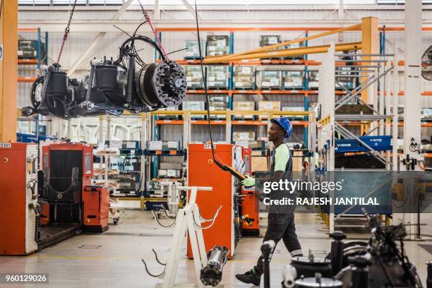 An employee carries out a demonstration in front of the South African President at the Volvo Automobile factory plant as he pays a visit to the Volvo...