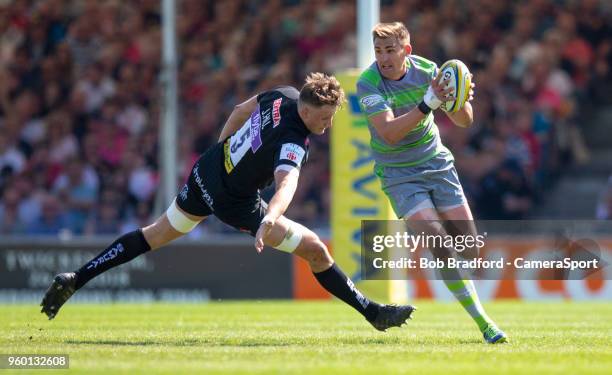 Newcastle Falcons' Toby Flood evades the tackle of Exeter Chiefs' Jonny Hill during the Aviva Premiership Semi Final between Exeter Chiefs and...