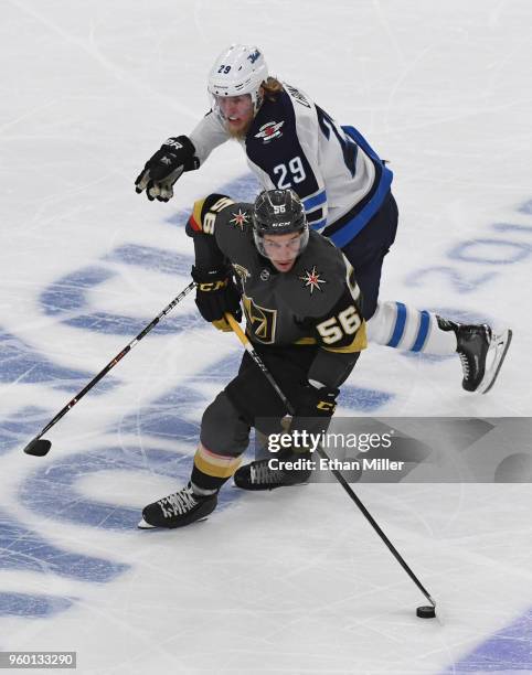 Erik Haula of the Vegas Golden Knights skates with the puck against Patrik Laine of the Winnipeg Jets in the third period of Game Four of the Western...
