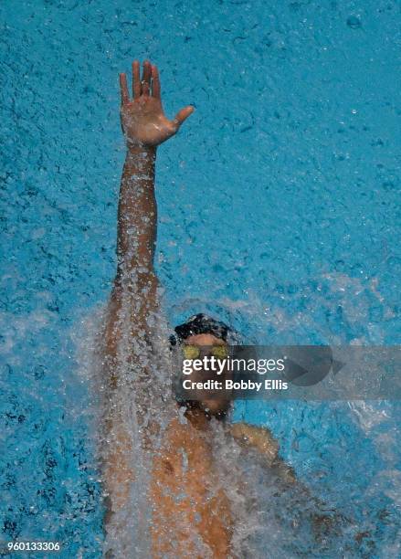 Matt Grevers competes in the men's 100 meter backstroke preliminary during the fourth day of competition at the TYR Pro Swim Series at Indiana...