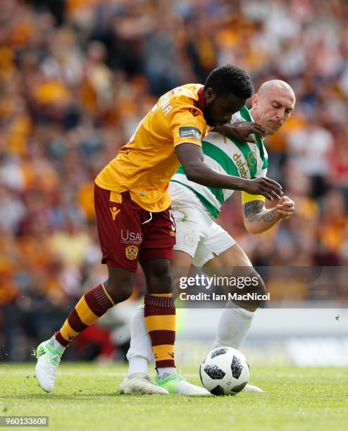 Gael Bigirimana of Motherwell vies with Scott Brown of Celtic during the Scottish Cup Final between Celtic and Motherwell at Hampden Park on May 19,...