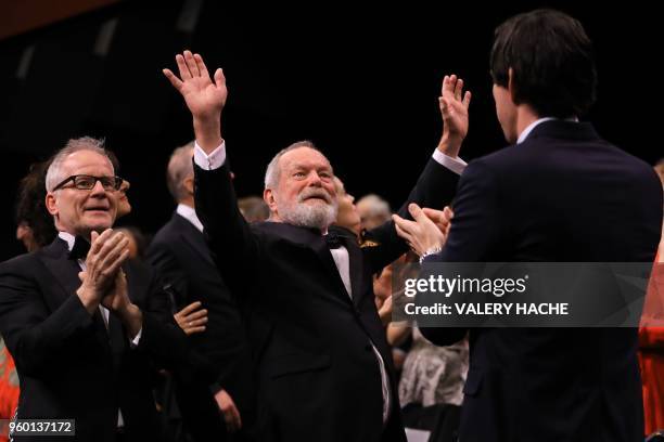 General Delegate of the Cannes Film Festival Thierry Fremaux and US actor Adam Driver applaud as US-British director Terry Gilliam waves on May 19,...