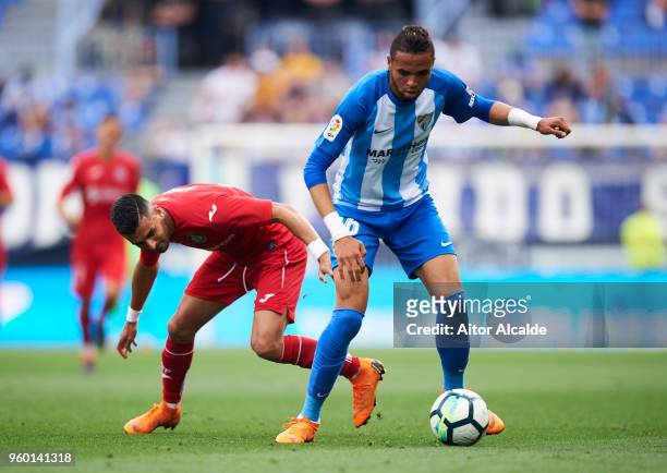 Youssef En-Nesyri of Malaga CF duels for the ball with Angel Luis Rodriguez of Getafe CF during the La Liga match between Malaga CF and Getafe CF at...
