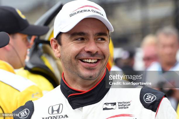 Oriol Servia, driver of the Scuderia Corsa Racing Honda, smiles as he makes his way down pit lane to his car during qualifying for the Indianapolis...