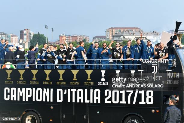 Juventus' players parade aboard an open-top bus to celebrate the "scudetto" with supporters in Turin after the Italian Serie A last football match of...