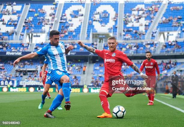 Alejandro Robles of Malaga CF duels for the ball with Vitorino Antunes of Getafe CF during the La Liga match between Malaga CF and Getafe CF at...