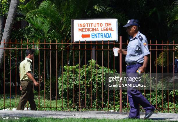 Police officers are seen outside the Institute of Legal Medicine in Havana, where relatives of the victim of the plane that crashed shortly after...