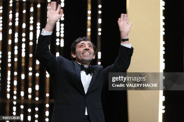 Italian actor Marcello Fonte reacts on stage on May 19, 2018 after he was awarded with the Best Actor Prize for his part in "Dogman" at the 71st...