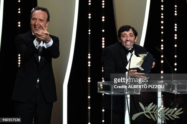 Italian actor Marcello Fonte poses on stage next to Italian director Roberto Benigni after he was awarded with the Best Actor Prize for his part in...
