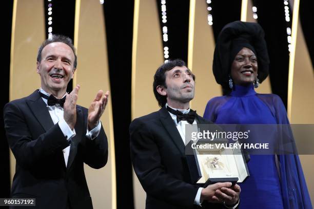 Italian actor Marcello Fonte poses on stage with Italian actor Roberto Benigni and Burundian singer and member of the Feature Film Jury Khadja Nin on...