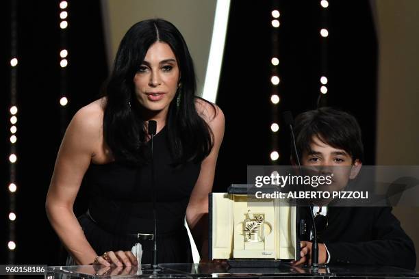 Lebanese director and actress Nadine Labaki delivers a speech on stage next to Syrian actor Zain al-Rafeea after she was awarded with the Jury Prize...