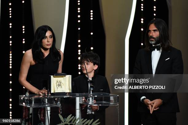 Lebanese director and actress Nadine Labaki delivers a speech on stage next to Syrian actor Zain al-Rafeea and her husband Lebanese producer Khaled...
