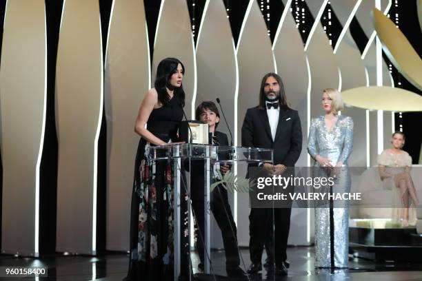 Lebanese director and actress Nadine Labaki delivers a speech on stage as Syrian actor Zain al-Rafeea and Lebanese producer Khaled Mouzanar look on,...