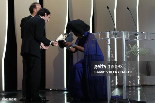 Burundian singer and member of the Feature Film Jury Khadja Nin presents Italian actor Marcello Fonte with the Best Actor Prize for his part in...
