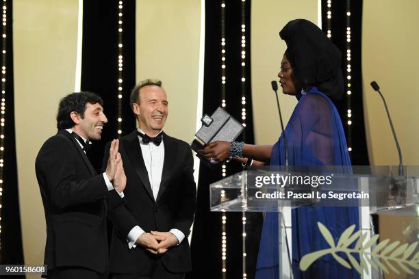 Roberto Benigni and Jury member Khadja Nin present actor Marcello Fonte the Best Actor award for his role in 'Dogman' on stage during the Closing...