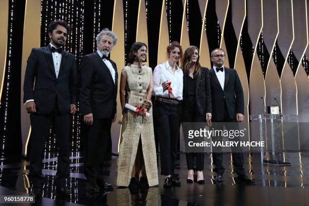 Iranian actress and daughter of Jafar Panahi Solmaz Panahi and Italian director Alice Rohrwacher stand on stage with Iranian actor and son of Jafar...