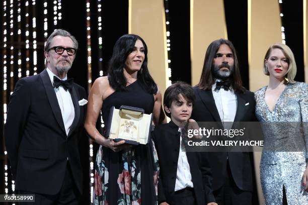 Lebanese director and actress Nadine Labaki delivers a speech on stage next to Syrian actor Zain al-Rafeea and her husband Lebanese producer Khaled...