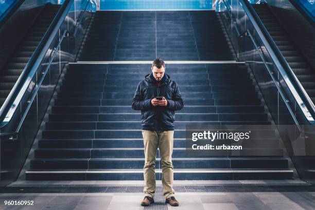 typing on smartphone - transportation building type of building stock pictures, royalty-free photos & images