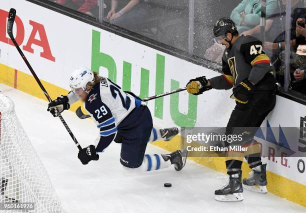 Patrik Laine of the Winnipeg Jets gets tripped up against Luca Sbisa of the Vegas Golden Knights during the first period of Game Four of the Western...