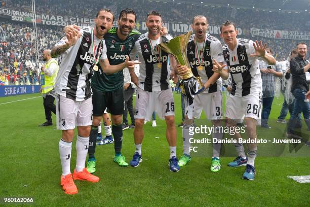 Claudio Marchisio, Gianluigi Buffon, Andrea Barzagli, Giorgio Chiellini and Stephan Lichtsteiner of Juventus celebrate holding the trophy after...