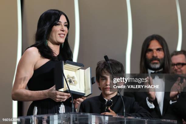 Lebanese director and actress Nadine Labaki poses on stage next to Syrian actor Zain al-Rafeea and her husband Lebanese producer Khaled Mouzanar...