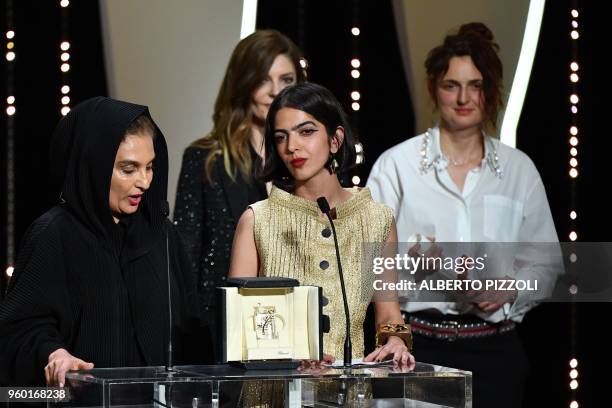 Iranian actress and daughter of Jafar Panahi Solmaz Panahi delivers a speech on stage on May 19, 2018 next to co-winner Italian director Alice...