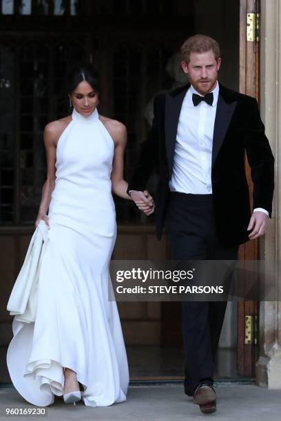 The newly married Britain's Prince Harry, Duke of Sussex, and Meghan Markle, Duchess of Sussex, leave Windsor Castle in Windsor on May 19, 2018 after...