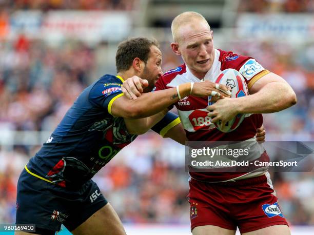 Wigan Warriors' Liam Farrell is tackled by Warrington Wolves 's Tyrone Roberts during the Betfred Super League Round 15 match between Wigan Warriors...