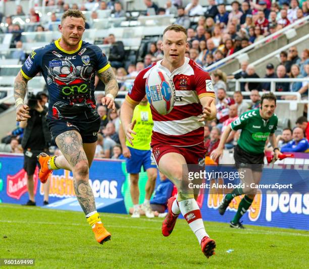 Wigan Warriors' Liam Marshall beats Warrington Wolves' Josh Charnley on the way to scoring his side's fifth try during the Betfred Super League Round...