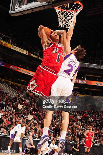 Derrick Rose of the Chicago Bulls dunks against Goran Dragic of the Phoenix Suns in an NBA Game played on January 22, 2010 at U.S. Airways Center in...