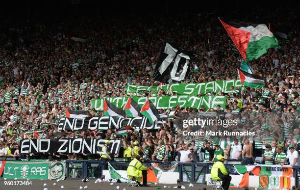 Celtic fans hold up signs showing support for Palestine during the Scottish Cup Final between Celtic and Motherwell at Hampden Park on May 19, 2018...