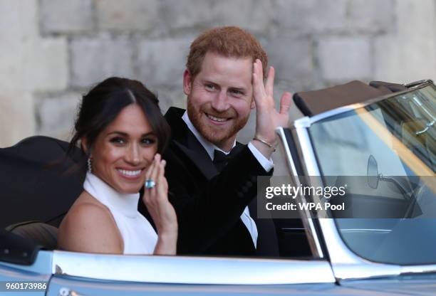 Duchess of Sussex and Prince Harry, Duke of Sussex wave as they leave Windsor Castle after their wedding to attend an evening reception at Frogmore...