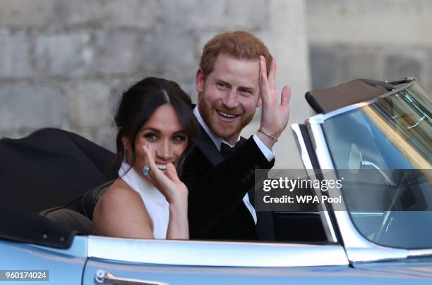 Prince Harry, Duke of Sussex and Meghan, Duchess of Sussex wave as they leave Windsor Castle after their wedding to attend an evening reception at...
