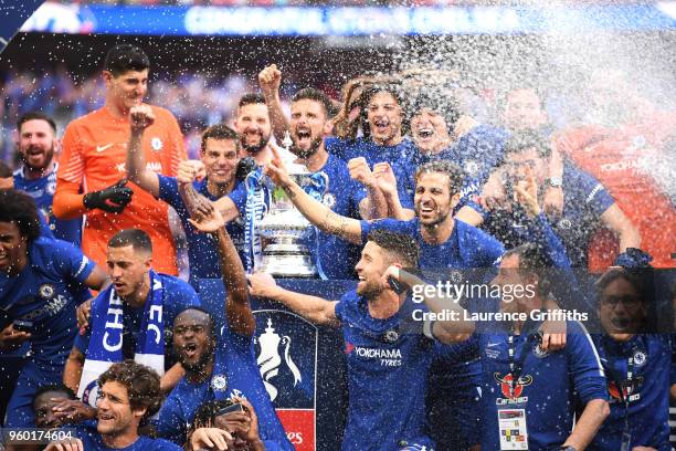 Olivier Giroud of Chelsea holds the Emirates FA Cup trophy in celebration of his side's win, with team mates following The Emirates FA Cup Final...