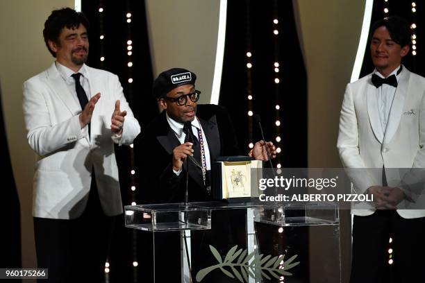 Director Spike Lee delivers a speech on stage on May 19, 2018 flanked by US-Puerto Rican actor and President of the Un Certain Regard jury Benicio...