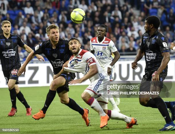 Lyon's French midfielder Nabil Fekir vies with Nice's French defender Arnaud Souquet and Nice's Brasilian defender Santos Marlon during the French L1...