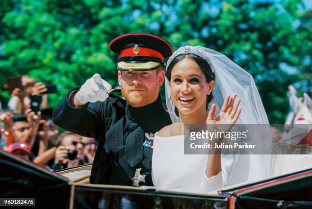 Prince Harry, Duke of Sussex and the Duchess of Sussex in the Ascot Landau carriage during the procession after getting married at St George's...
